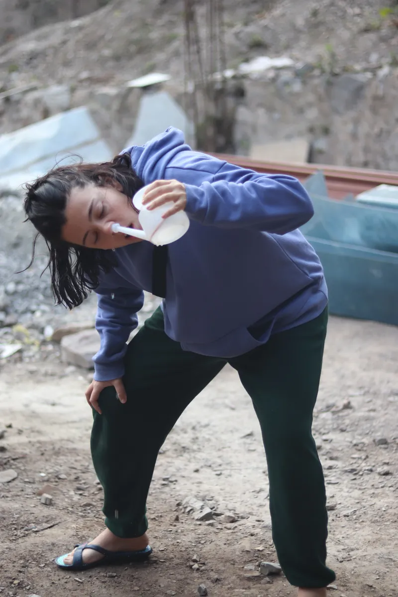 Student performing a shatkarma cleansing practice outdoors during yoga training in Rishikesh