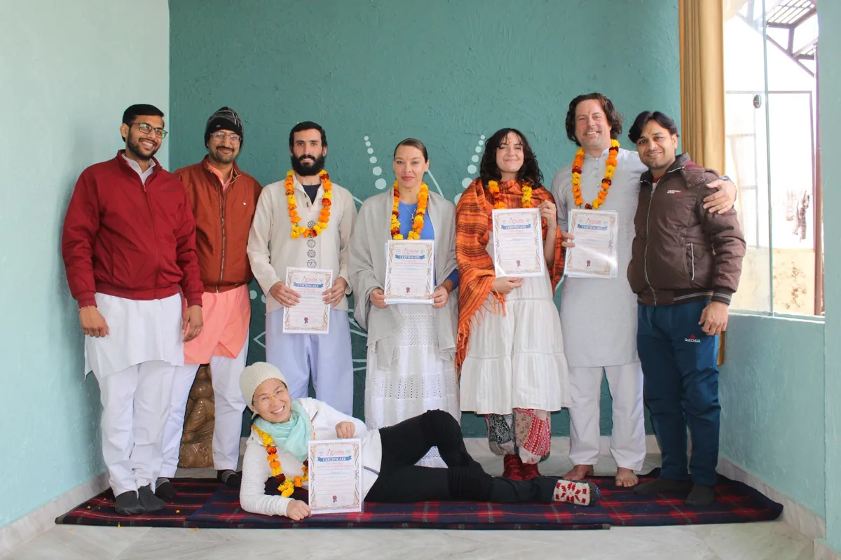 Group of students holding certificates after completing their yoga foundation course in Rishikesh