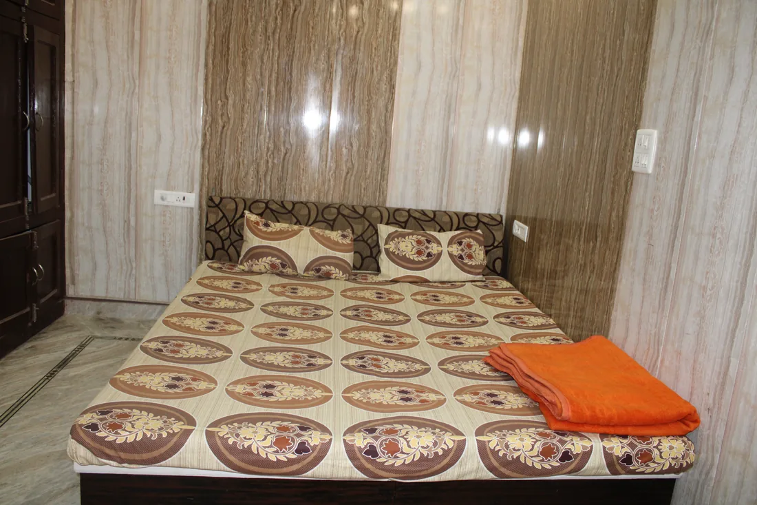 Twin shared guest room prepared for a Panchakarma guest at Sri Yoga Ashram
